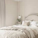 Modern bedroom with serene color palette and plush furnishings.